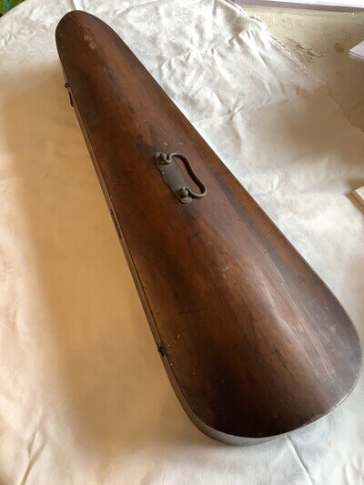 Old wooden violin case containing a more modern violin