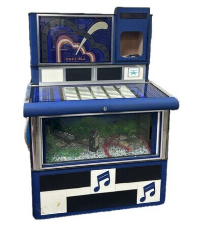Rock Ola Juke Box converted into a fish tank, H 55 Inc, W 38 Inc, D25 Inc