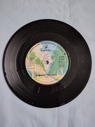 AMERICA "WOMAN TONIGHT" 1975 7" VINYL SINGLE IN A PLAIN SLEEVE